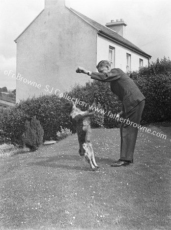 MAN WITH JUMPING DOG